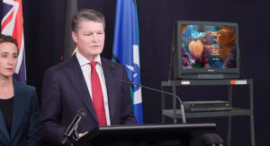 Relief-Premier Carroll wheels out TV so press pack can watch a movie 